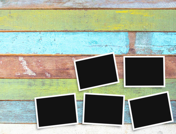 istock Black and white old blank photo frame on office desk 1299376933