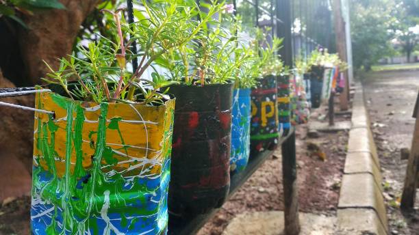 istock Rows of hanging flower bottle pots 1299377787