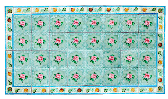 Rows of antique Nyonya Tiles with pink roses with green background. Vintage wall tile in penang.