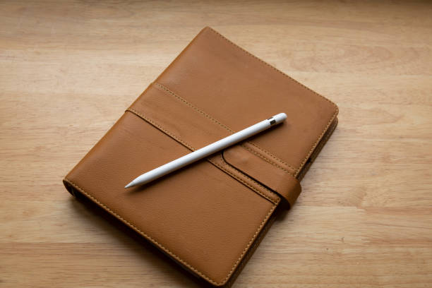 istock top view of brown leather notebook with pen on wooden table 1299379402