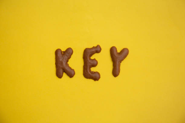 istock Word KEY arranged from homemade chocolate cookie alphabet on yellow table 1299380243
