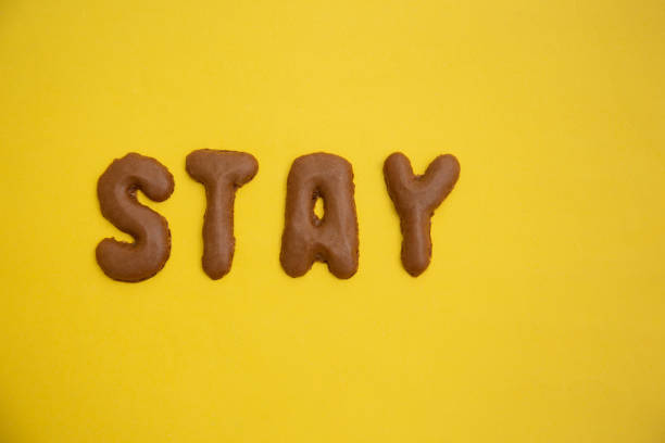 istock Word STAY arranged from homemade chocolate cookie alphabet on yellow table 1299380270