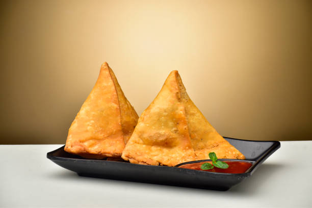 istock Samosa with chutney in plate, asian breakfast aloo samosa 1299380316