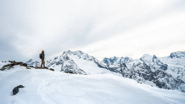 istock Traveler in the snowcapped mountains 1299384037