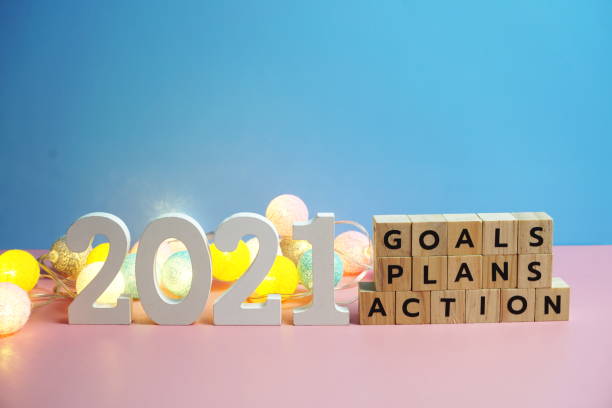 istock 2021 new year goals, plan, action alphabet letters on blue and pink background 1299385417