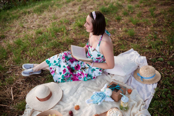 istock A young woman sitting on a picnic in a park 1299386195