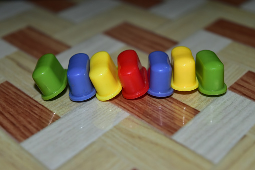 Colourful plastic objects on a tiles surface