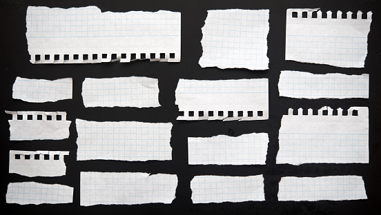 Torn papers on a black background