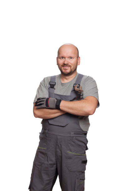 istock Mechanic in working outfit holding crossed hands isolated on a white background 1299388189