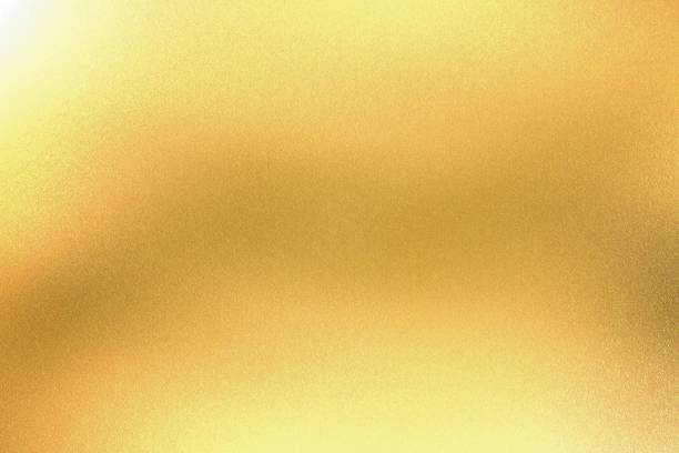 istock Light shining on yellow foil glitter metallic wall with copy space, abstract texture background 1299388553