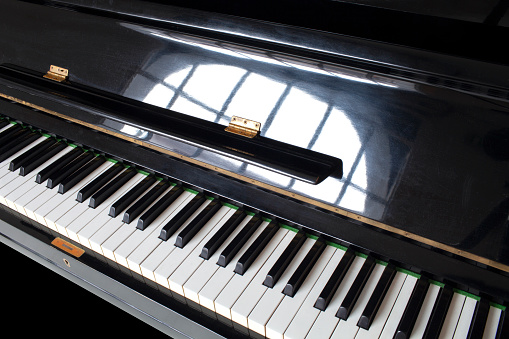 Piano keys on black piano.