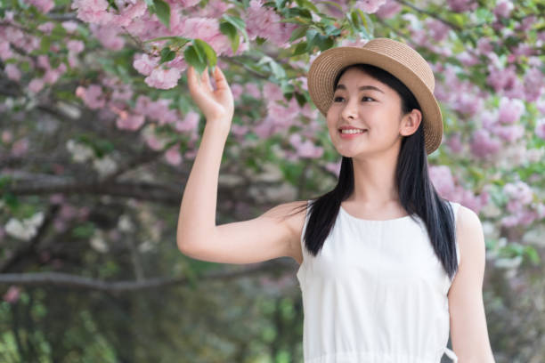 istock beautiful girl and cherry blossom 1299390141