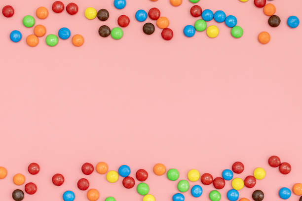 istock empty copy space for text in the middle, top view of Colorful chocolate coated candy on pink background with valentines. Valentines day concept festive food gifts 1299390348