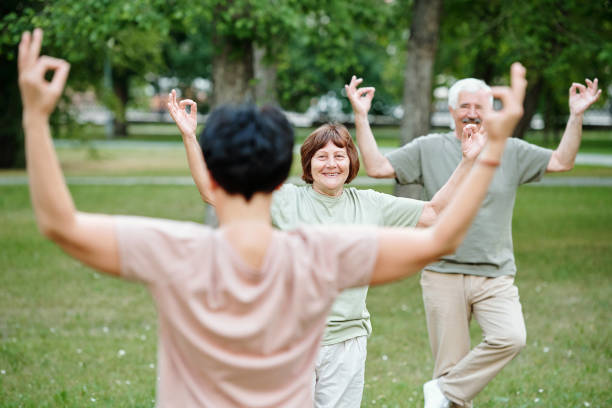 istock Senior people doing yoga 1299392791