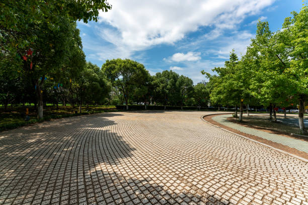 istock Empty street at the nice and comfortable great garden under lovely blue sky 1299394484
