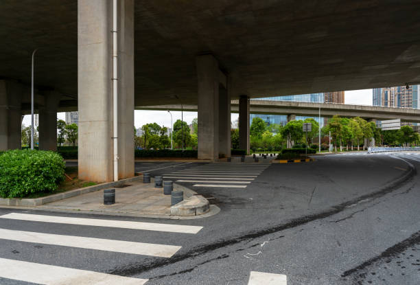 istock Concrete structure and asphalt road space under the overpass in the city 1299394866