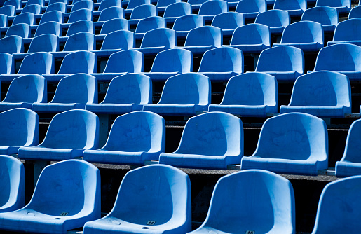 empty outdoor arena. concept of fans. chairs for audience. cultural environment concept. color and symmetry. empty seats. modern stadium. blue tribunes. seats of tribune on sport stadium.