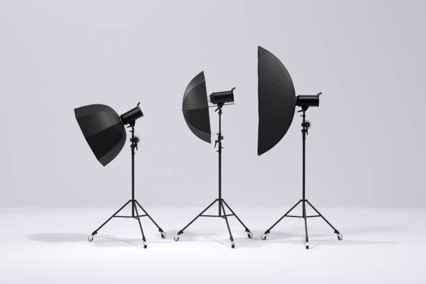 istock Photo studio lighting stands with flash, umbrella and softbox on the white 1299398923