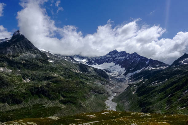 istock high mountains with a glacier and white clouds on the sky 1299401801