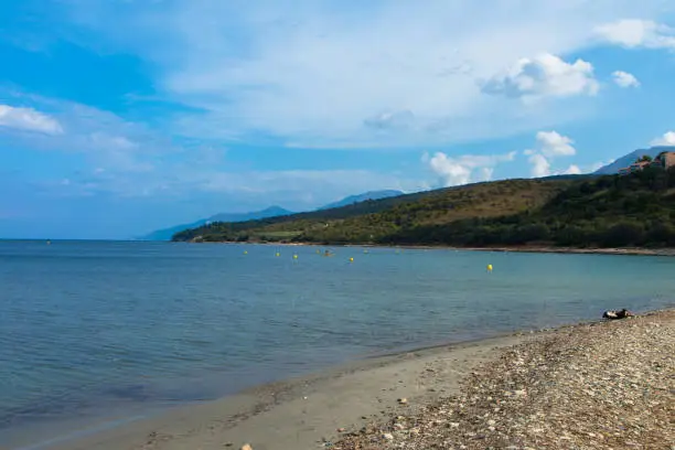 Photo of Panoramic view of the Plage D'Orzo and the hills with a holiday resort in Corsica, France.