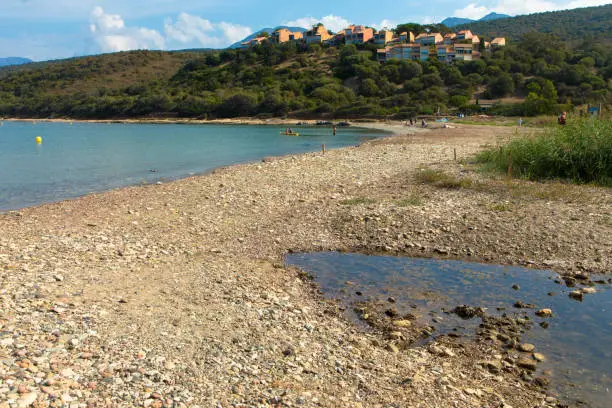 Photo of Panoramic view of the Plage D'Orzo and the hills with a holiday resort in Corsica, France.