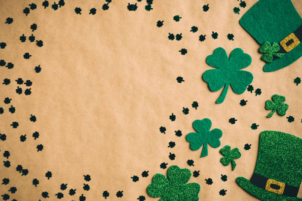 istock Happy Saint Patrick's Day concept. Flat lay composition with green hats and shamrock leaves on kraft paper background. St Patricks Day banner design, poster template. 1299403382