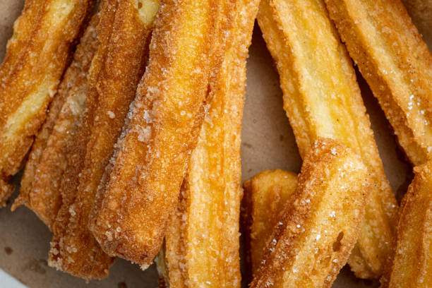 istock Traditional churros sticks with cinnamon and sugar powder, top view flat lay 1299403423