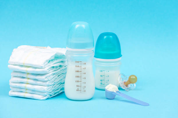 istock Set of different baby accessories and feeding mixture in bottles 1299403452