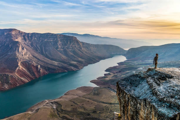 istock Female Soldier Standing on top of Cliff at sunset 1299403832