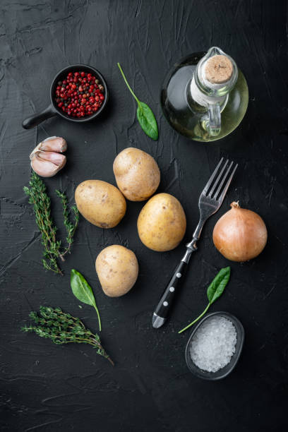 istock Fresh Pile of potatoes, on black background, top view flat lay 1299404469