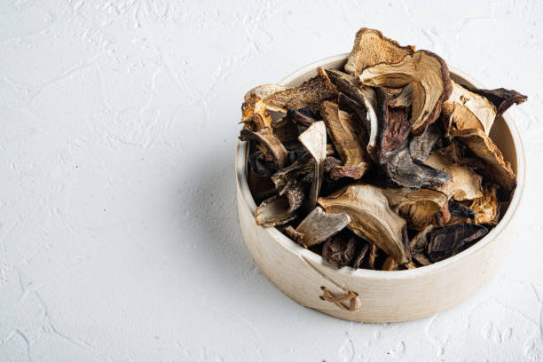 istock Boletus wild dried mushrooms, on white background , with space for text  copyspace 1299405774