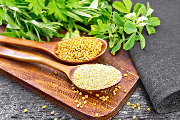 istock Fenugreek in two spoons with herbs on black board 1299405826