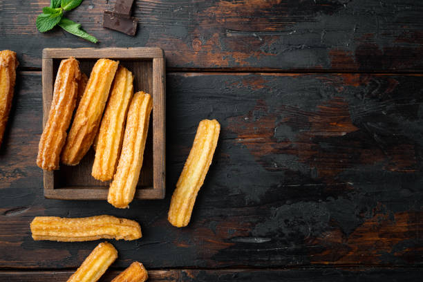 istock Churros with chocolate Traditional Spanish cusine, on old dark  wooden table background, top view flat lay with space for text, copyspace 1299406994