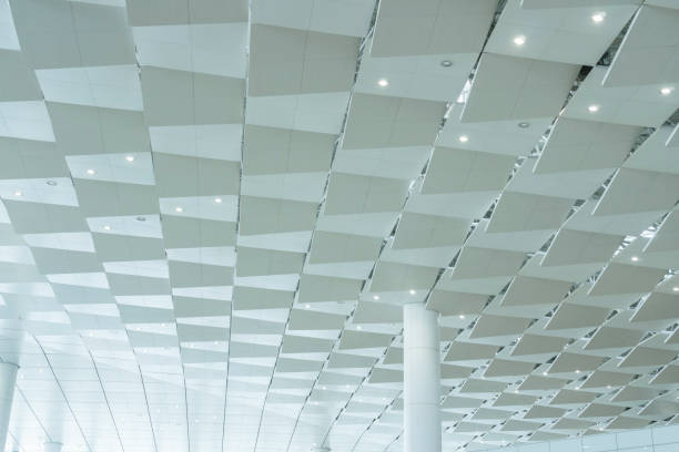 istock Low angle view of modern ceiling and windows of airport terminal 1299408952