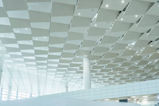 istock Low angle view of modern ceiling and windows of airport terminal 1299408970