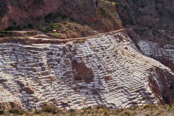 Photo of Salt ponds of Maras in the Sacred Valley of the Incas, close to Urubamba, a popular tourist travel destination near Cuzco and Machu Picchu in Peru. Basins for salt production of salt industry