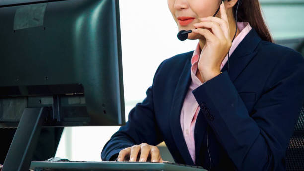 istock Business people wearing headset working in office 1299410468
