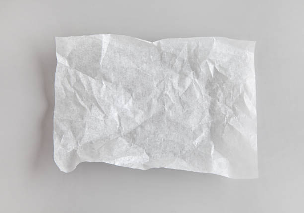 istock crumpled sheet of white baking paper on grey kitchen table, top view 1299413011