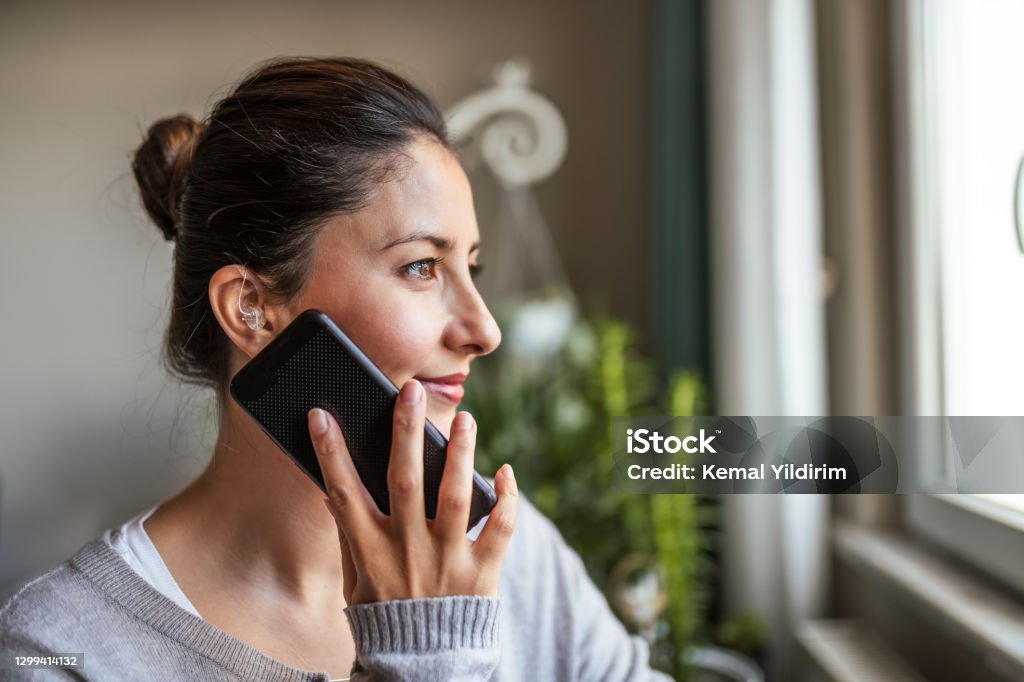 Young Adult woman did not expect Hearing Aid at this age Young Adult woman did not expect Hearing Aid at his age Hearing Aid Stock Photo