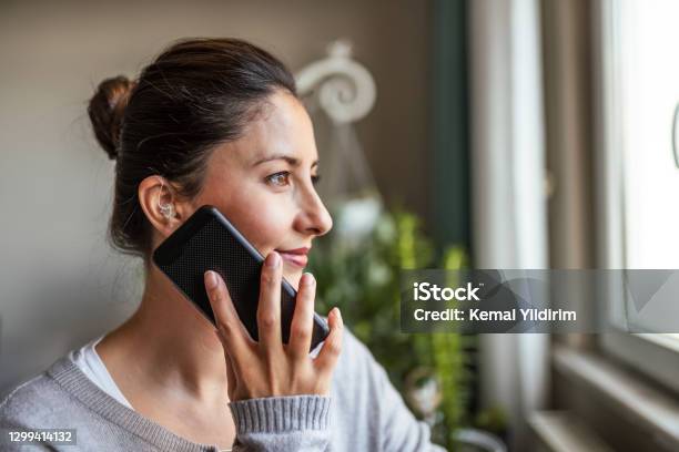 Young Adult Woman Did Not Expect Hearing Aid At This Age Stock Photo - Download Image Now