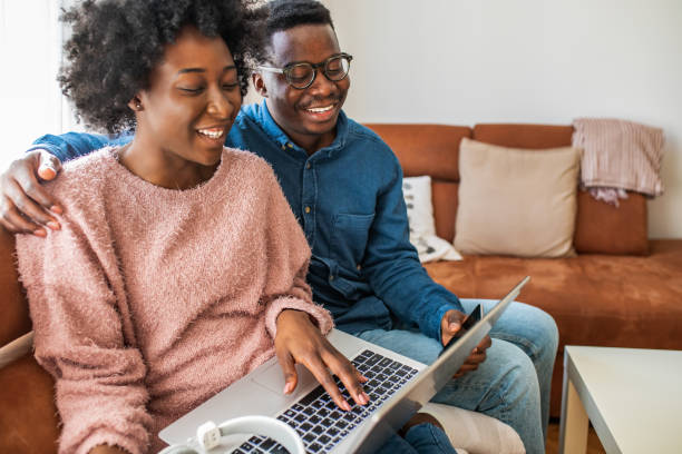 istock Couple relaxing at home and using laptop 1299415447