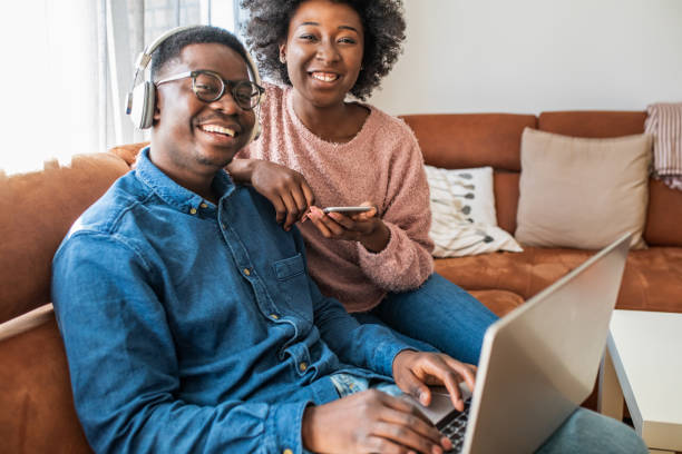 istock Couple relaxing at home and using laptop 1299415901
