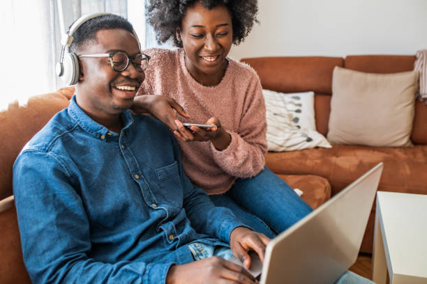 istock Couple relaxing at home and using laptop 1299416003