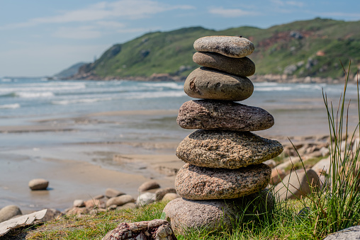 Balance stones. Pebbles on the beach by the sea.\nPraia D'água - Ibiraquera - Santa Catarina - Brazil