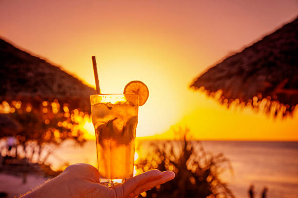 istock Tropical orange sunset relax view with fresh beverage 1299416134