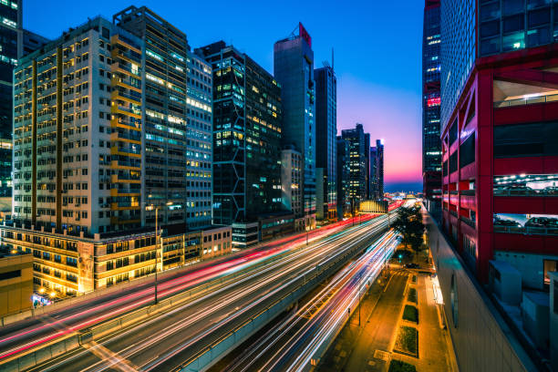 istock Traffic at bridge with sunset downtown in Hong Kong 1299416182