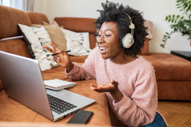 istock Beautiful young woman working at home and using laptop 1299416229