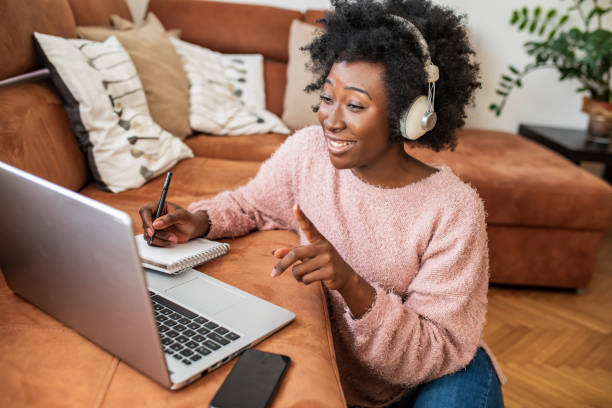 istock Beautiful young woman working at home and using laptop 1299416251