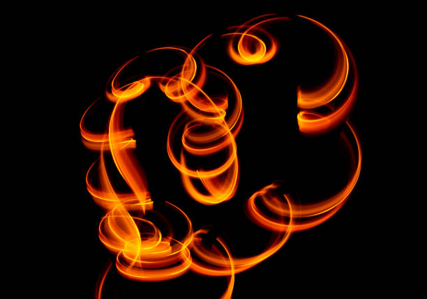 istock Light wave trail path, vibrant neon gold color in abstract swirls on a black background 1299416332