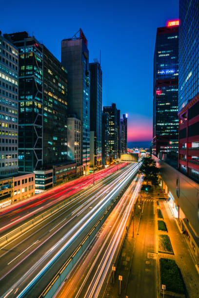 istock Traffic at bridge with sunset downtown in Hong Kong 1299416352